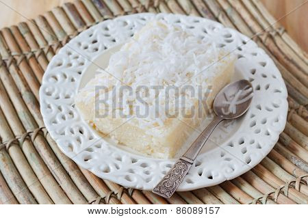 Sweet Couscous Pudding  With Coconut On White Plate With Spoon