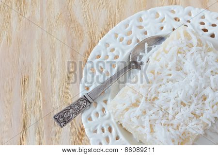 Sweet Couscous Pudding  With Coconut On White Vintage Plate With Spoon