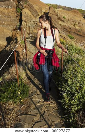 Young girl on the winding mountain trekking path at Pico do Areeiro, Madeira, Portugal
