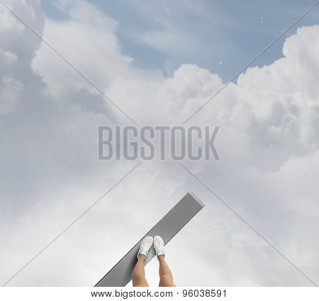 Woman standing on the edge of wooden board