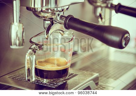 Prepares espresso in coffee shop ( Filtered image processed vintage effect. )