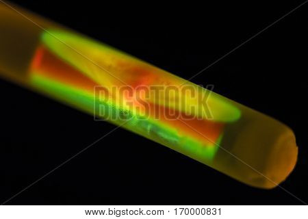 Two liquids mix after breaking the glass capillary in a chemiluminescent bracelet