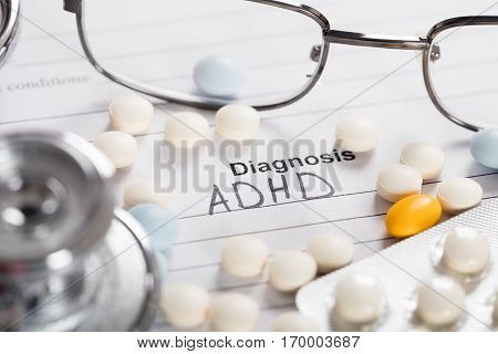 Pills;Glasses And Stethoscope With Text Diagnosis ADHD On Paper