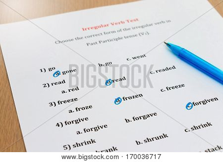 multiple choice english exam with pen on table