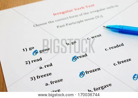 multiple choice english exam with pen on table