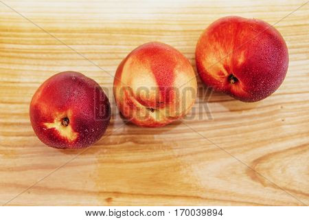 Beautiful fragrant ripe nectarines on the wooden board