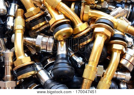 A top view image of several metal valve stems.