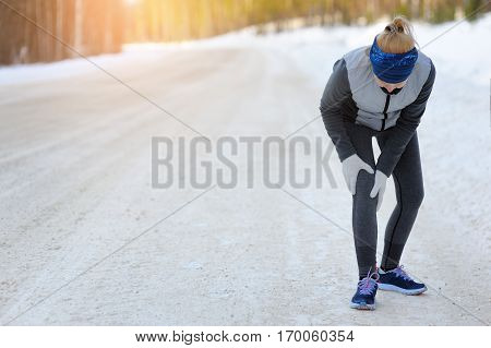 Injuries - Sports Running Knee Injury On Woman. Winter Marathon.