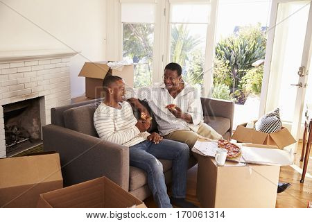Father And Adult Son Take A Break With Pizza On Moving Day
