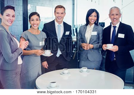 Portrait of businesspeople having tea during breaktime in office