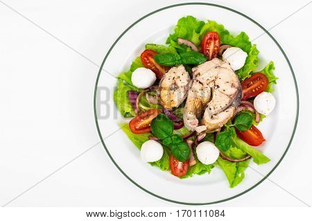 Vegetable salad with fish on plate. Studio Photo