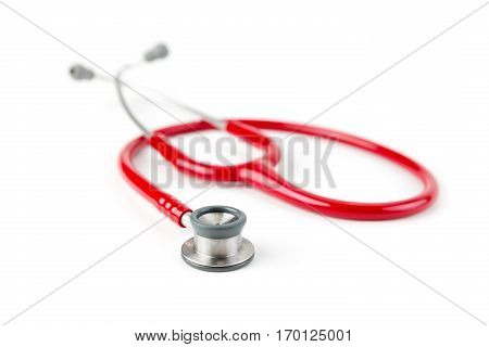 Red medical stetoskop isolated on a white background. Studio shot. Front View. Shallow depth of field. Child care.