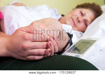 Close up picture of a bed ridden woman with high blood pressure