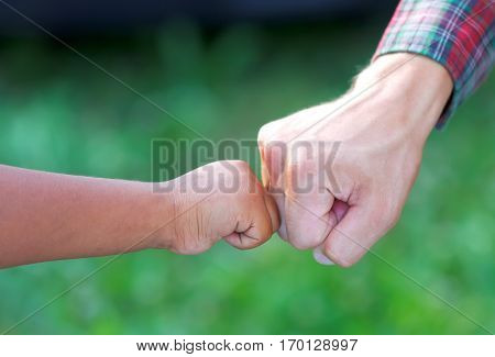 Close up picture of a caucasian and a romany kid's hands