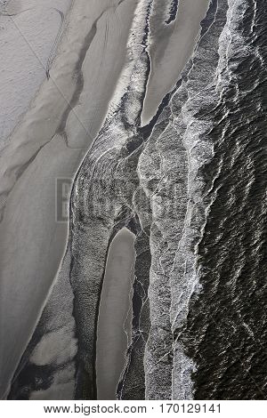 Aerial view of the shore with shapes lines and patterns formed by the waves on the sand Ameland islad Friesland The Netherlands