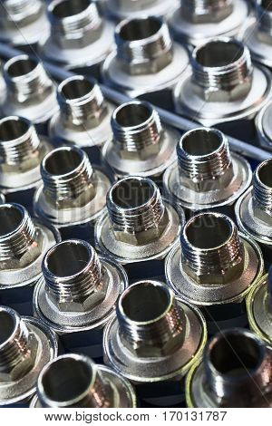 Plumbing connection fittings for plastic pipes. Orderly arranged in neat rows. Abstract industrial background.