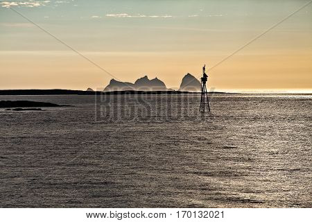 Midnight sun Norwegian Landscape with the mountain shape of Traena Island