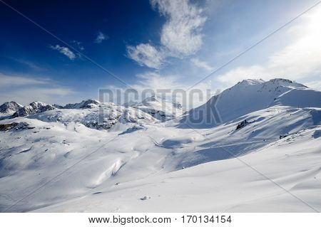 Alpine winter mountain landscape. French Alps covered with snow in sunny day. Val-d'Isere, France