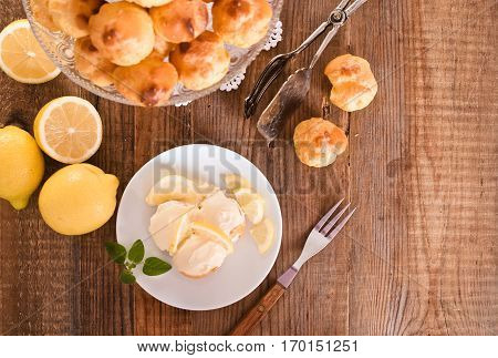Lemon Profiteroles with custard cream on white dish.