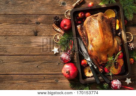 Roast duck with apples and oranges on baking tray. Cooking at Christmas time