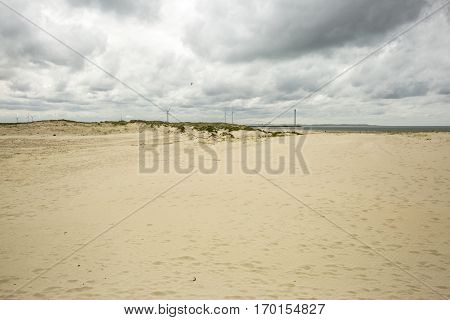 Seaside view with power windmills and dramatic sky, Haringvliet, The Netherlands