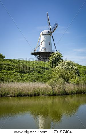 Typical Dutch landscape with a canal and a windmill, Molen de Koe, Veere, The Netherlands