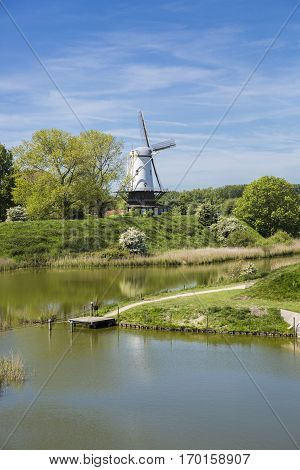 Typical Dutch landscape with a canal and a windmill, Molen de Koe, Veere, The Netherlands