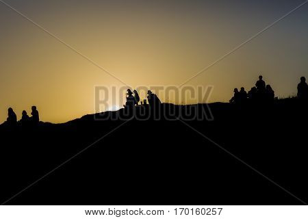 Traena festival 2014, people standing on the top of a hill dmiring the midnight sun