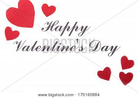 Valentine card with red heart on wooden desk.