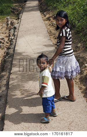POPOTOTAN ISLAND BUSUANGA PHILIPPINES - JANUARY 20,2012 - Boy and girl moving on the road to the village