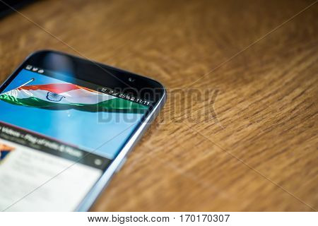 Smartphone On Wooden Background With 5G Network Sign 25 Per Cent Charge And India Flag On The Screen