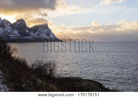 Norwegian landscape with a tiny road along the seaside in a fjord in the winter Nordland Norway