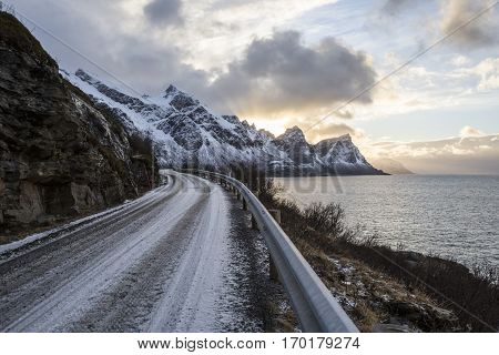 Norwegian landscape with a tiny road along the seaside in a fjord in the winter Nordland Norway