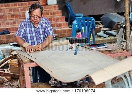 Nan Thailand 8 Dec 2016 Folk artisan is drawing lines for use in its original carved wood from handmade to make the entrance hall of the temple is in the local community by using folk wisdom at Wat Rong Ngae Nan Thailand