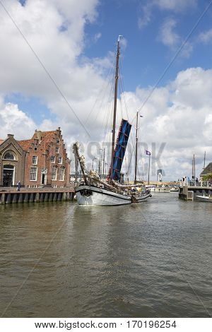 Noorderhaven canal with boats open bridge and houses in historic old town of Harlingen Friesland Netherlands