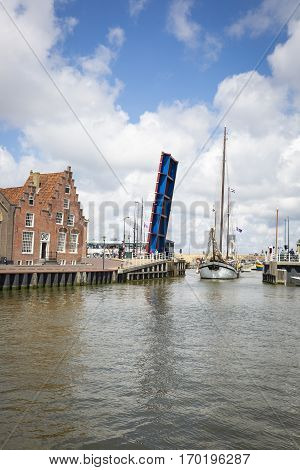 Noorderhaven canal with boats open bridge and houses in historic old town of Harlingen Friesland Netherlands