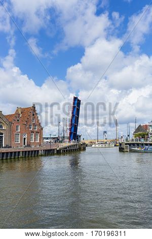 Noorderhaven canal with boats open bridge and houses in historic old town of Harlingen Friesland Netherlands