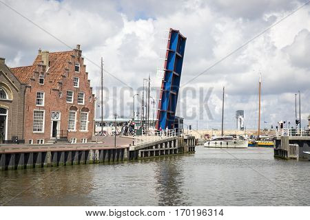 Noorderhaven canal with boats open bridge and houses in historic old town of Harlingen Friesland Netherlands