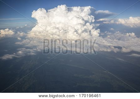 Close up on white fluffy storm clouds in front of blue sky