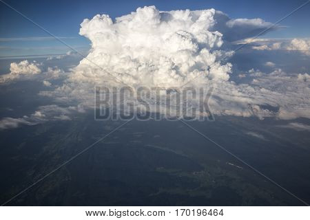 Close up on white fluffy storm clouds in front of blue sky