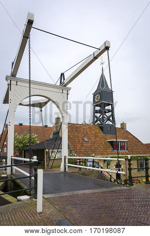 Dutch village with a small tow bridge and tower bell The Netherlands