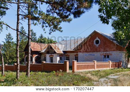 Taul Park, old ruined red village houses with fences, north of Moldova