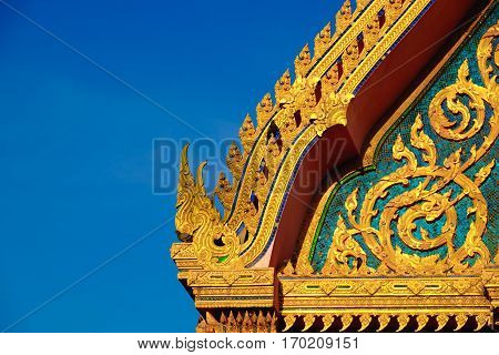 Gold Color Roof Of Buddhist Temple With Blue Sky Background.
