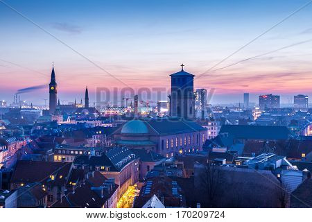 Cityscape of copenhagen in the bluehour Tower of city hall and a church
