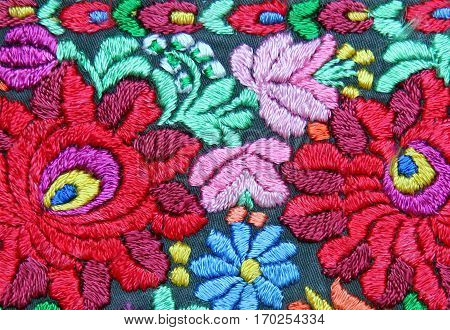Multicolor floral hand embroidery pattern macro image