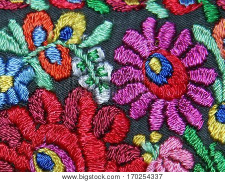 Multicolor floral hand embroidery pattern macro image