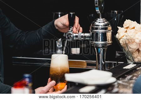 Bartender Pours A Glass Of Light Beer