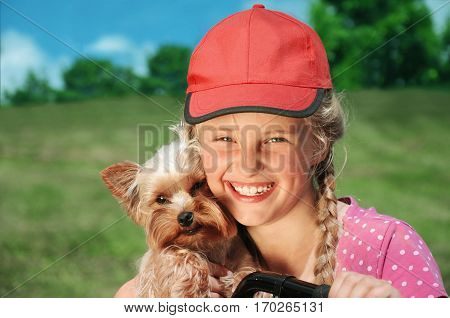 Little girl lovingly embraces his pet dog