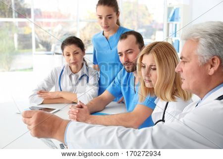 Team of doctors exploring roentgenogram at meeting