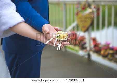 Beautiful wedding tradition to hang the lock on the bridge and throw the keys to the castle in the water